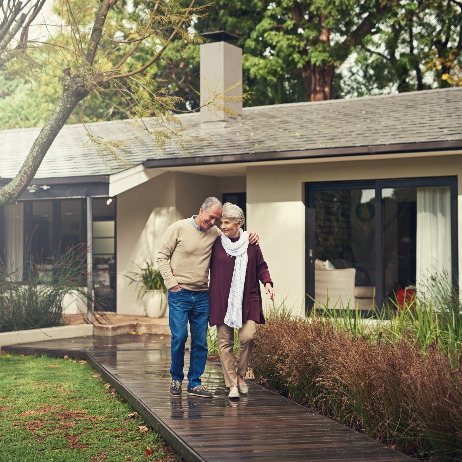 A young couple holding up the keys to their first home